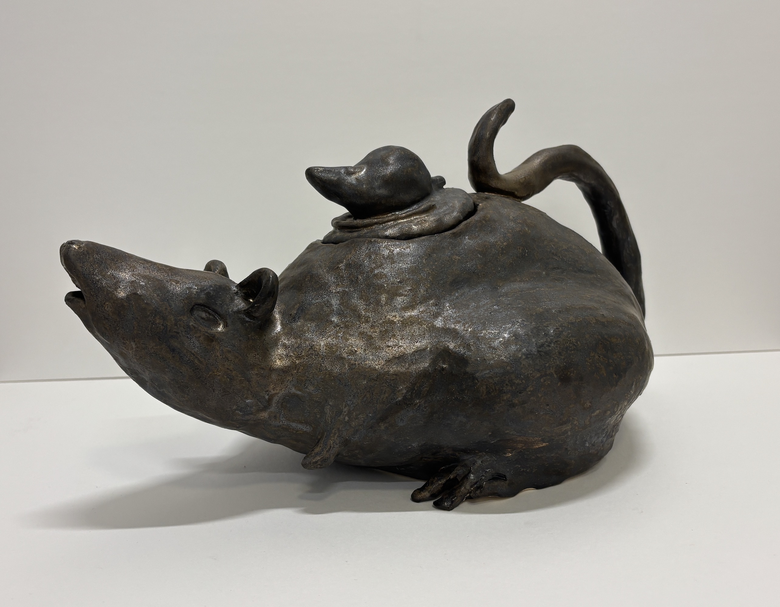 one large rat in shape of teapot